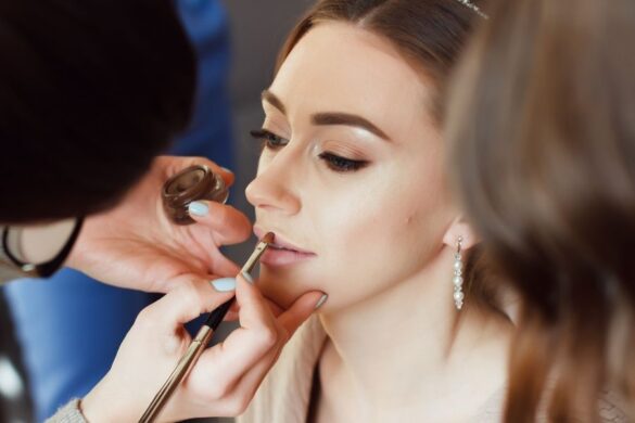 Makeup artist applying waterproof gym makeup for active woman