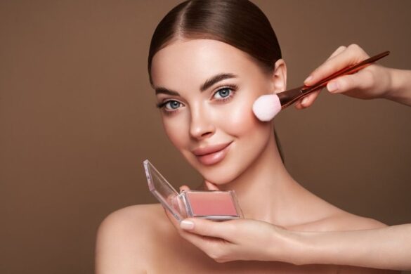 Woman with hooded eyes applying blush makeup with professional brush
