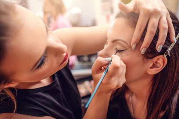 Professional makeup artist applying eyeliner following expert contouring guide techniques