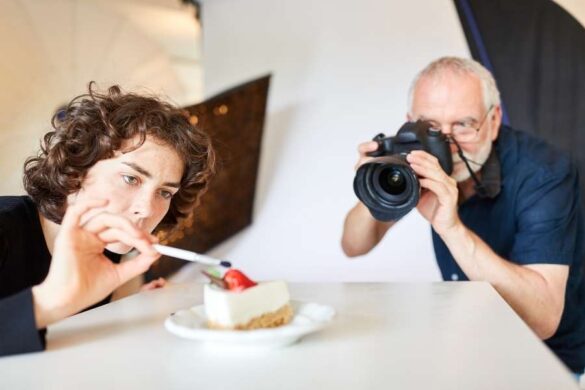 Professional food photography session capturing model eating dessert with photographer in studio