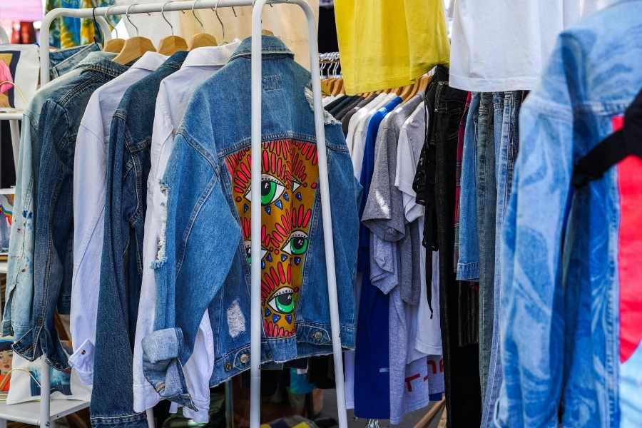 A rack of denim jackets and shirts showcasing a curated and stylish Eco-Friendly Closet.